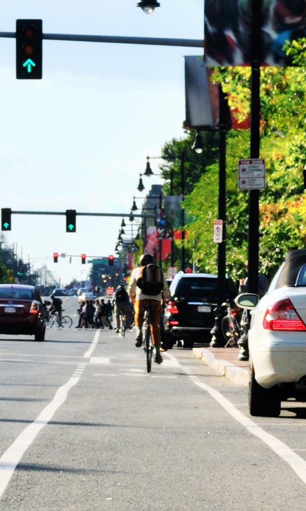 A cyclist riding in a marked bike lane alongside traffic