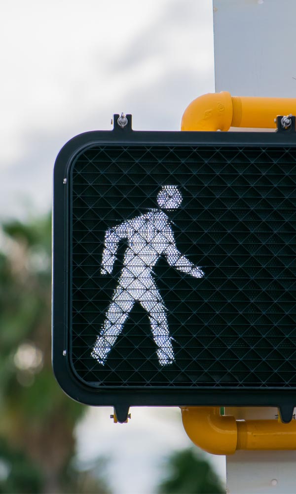 A pedestrian walk signal at a crosswalk