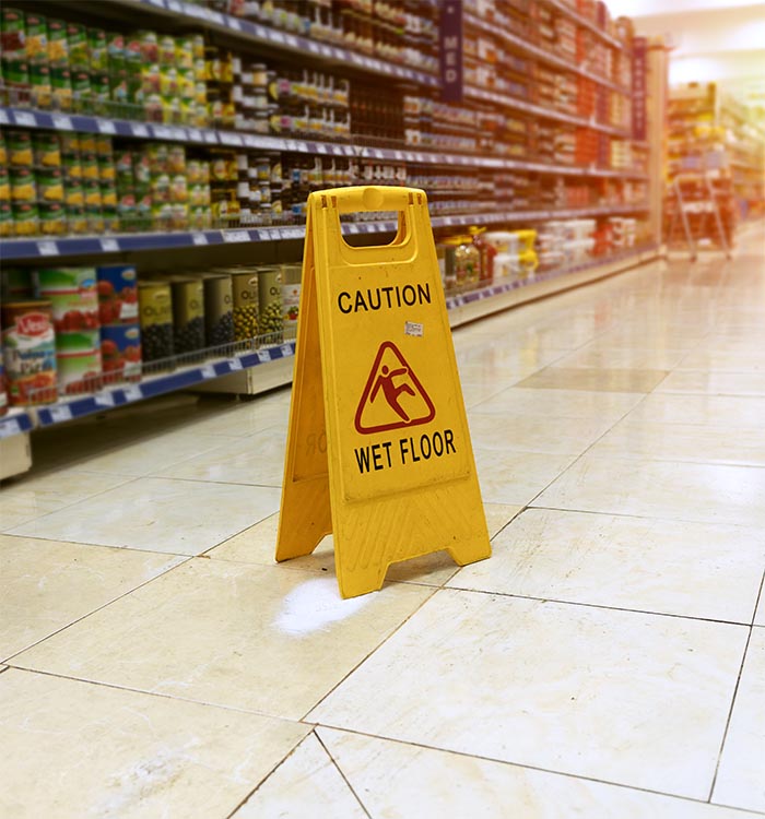 A caution wet floor sign in a store aisle